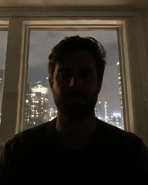 Bad photo: a man backlit at night with a dark face